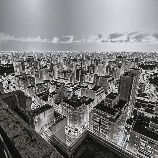 A solarized black and white view across a dense city of high rises